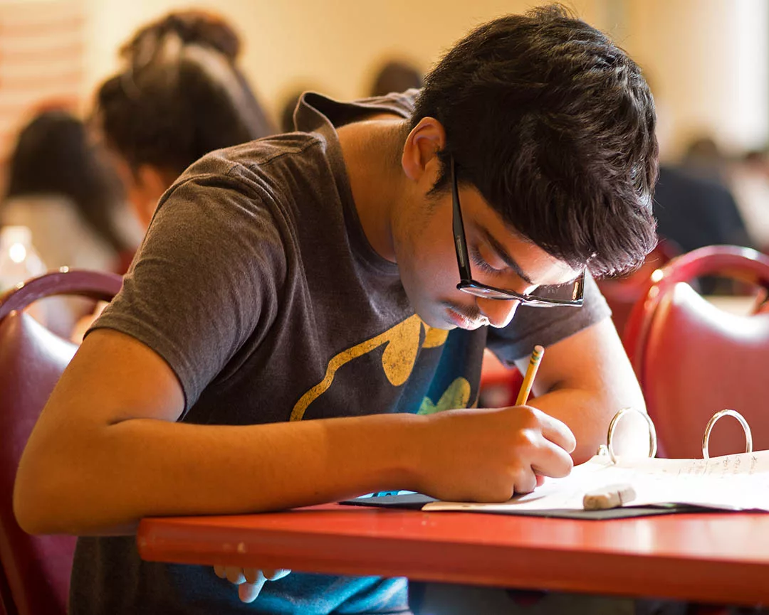 High school student works on an exam