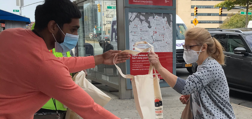 COVID-Free Queens from Sunnyside Community Services provides masks and information to the public.